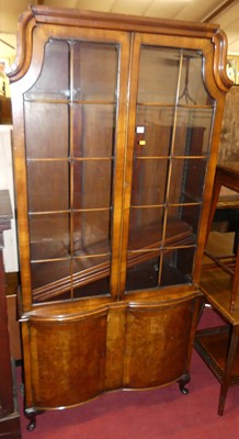 Lot 1364 - A walnut and figured walnut bookcase cupboard...