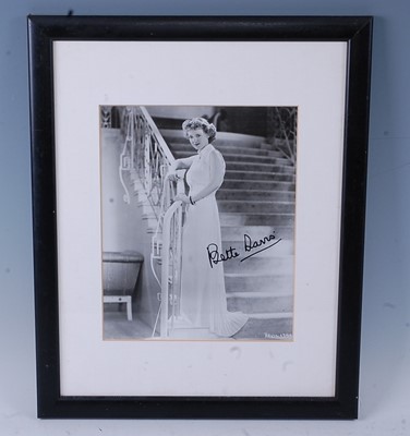 Lot 1129 - Bette Davis, (1908-1989), a black and white...
