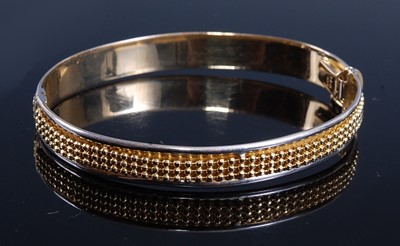 Lot 2172 - A yellow and white metal hinged hollow oval...