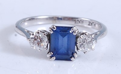 Lot 2165 - A white metal, sapphire and diamond three...