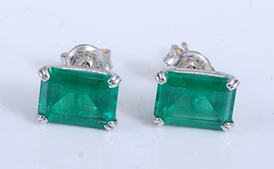 Lot 2188 - A pair of white metal emerald single stone...