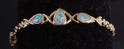 Lot 2169 - A yellow metal opal bracelet, comprising three...