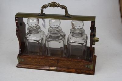 Lot 113 - An early 20th century oak three-bottle...