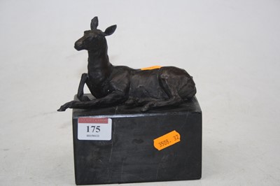 Lot 175 - A bronze model of a recumbent deer on black...