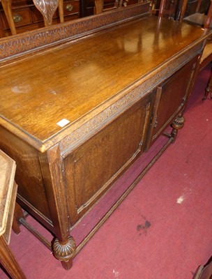 Lot 1375 - An early 20th century oak ledgeback two-door...