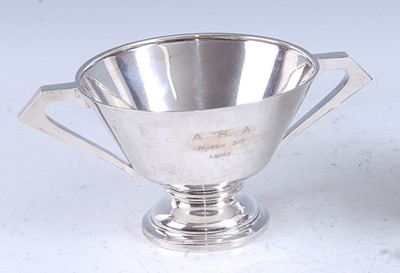 Lot 214 - An early Art Deco silver twin handled pedestal...