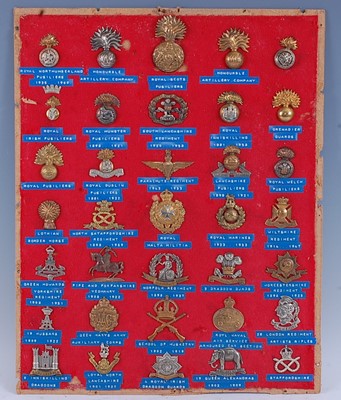 Lot 235 - A collection of cap badges and insignia to...