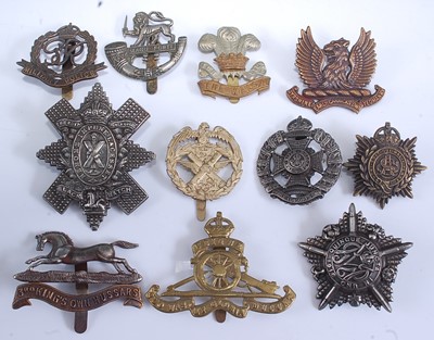 Lot 232 - A collection of cap and glengarry badges to...