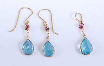 Lot 1170 - A pair of yellow metal, blue topaz and garnet...
