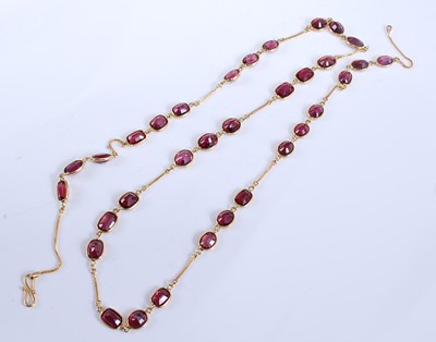 Lot 2191 - A yellow metal garnet necklet, comprising 33...