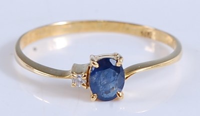 Lot 434 - A yellow metal, sapphire and diamond two stone...