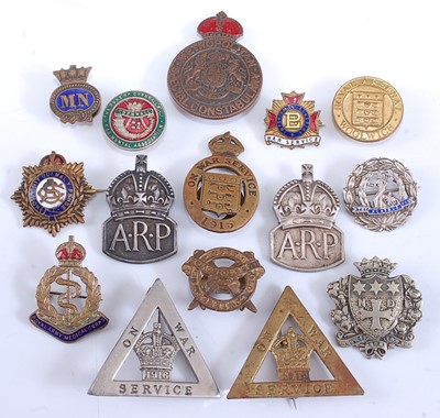 Lot 100 - A collection of military and related badges to...