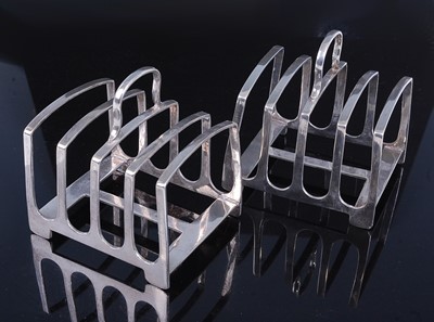 Lot 2132 - A pair of Edwardian silver four division toast-...