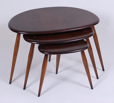 Lot 508 - A 1960s Ercol dark elm nest of three 'pebble'...