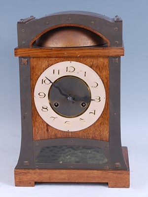 Lot 311 - An Art Nouveau oak and brass bound mantel...