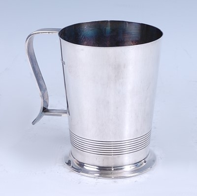 Lot 243 - An Art Deco silver tankard, the plain tapering...