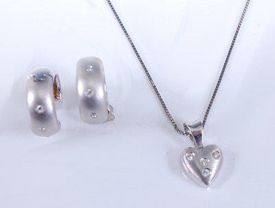 Lot 2537 - A white gold diamond pendant and earring set,...