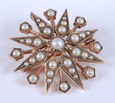 Lot 2551 - A 9ct yellow gold pearl eight-ray star brooch,...
