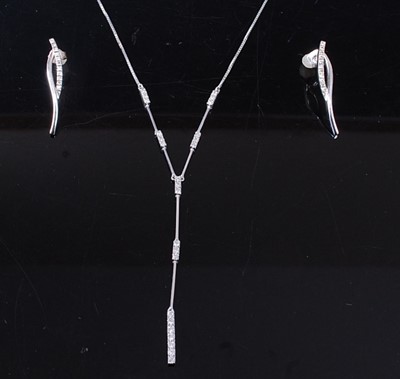 Lot 2574 - An 18ct white gold diamond pendant and earring...