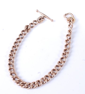 Lot 2582 - A rose metal curblink bracelet with T bar and...