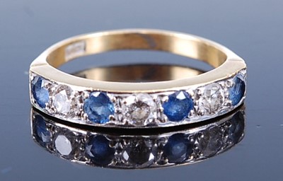 Lot 2596 - A yellow metal, sapphire and diamond half hoop...