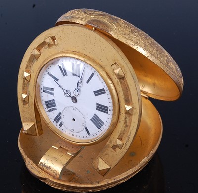 Lot 319 - An early 20th century travel clock, the oval...
