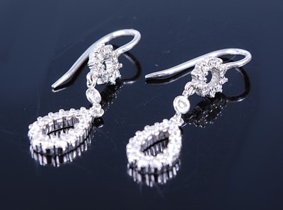Lot 2630 - A pair of white metal diamond set drop...