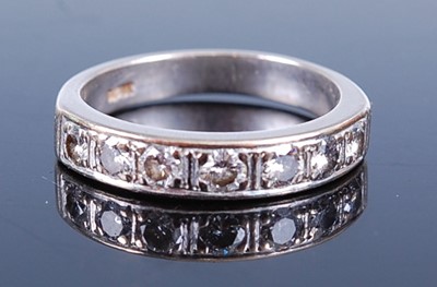 Lot 2627 - A white metal diamond half hoop eternity ring,...
