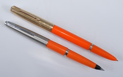 Lot 96 - Two Parker fountain pens in orange, one being...