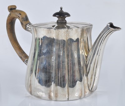 Lot 1108 - A George V silver teapot, of fluted lightly...