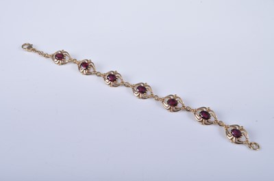 Lot 2661 - A 9ct yellow gold and garnet bracelet, having...