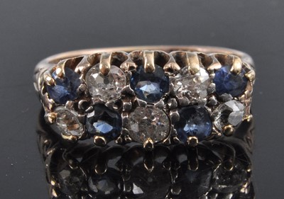 Lot 2673 - An 18ct gold, sapphire and diamond half hoop...