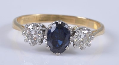 Lot 2665 - An 18ct gold, sapphire and diamond three stone...