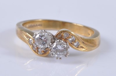 Lot 2668 - A contemporary 18ct gold diamond crossover...