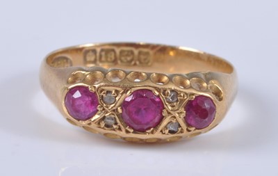 Lot 2685 - An 18ct gold, ruby and diamond ring, arranged...