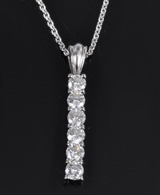 Lot 1129 - A contemporary 18ct white gold bar pendant,...