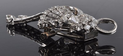 Lot 1142 - An Art Deco white metal diamond swag and bow...