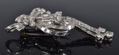 Lot 1142 - An Art Deco white metal diamond swag and bow...