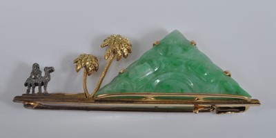Lot 1134 - A yellow metal bar brooch, featuring a carved...