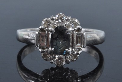 Lot 1153 - A platinum tourmaline and diamond oval cluster...
