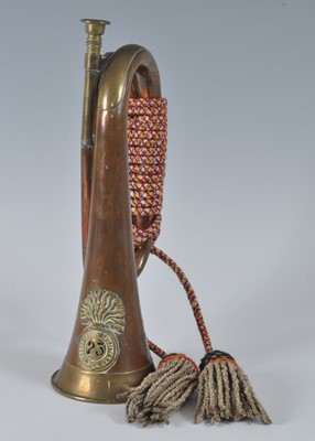 Lot 62 - A copper and brass bugle with applied badge...