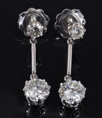 Lot 1161 - A pair of white metal diamond drop earrings,...