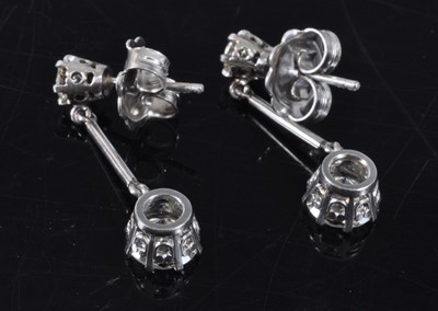 Lot 1161 - A pair of white metal diamond drop earrings,...