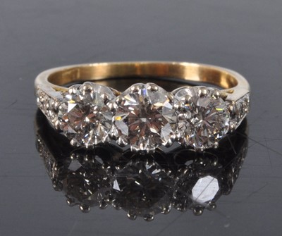 Lot 1162 - A yellow and white metal diamond three stone...