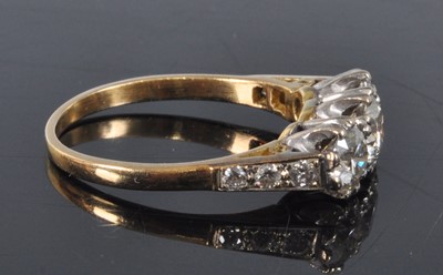 Lot 1162 - A yellow and white metal diamond three stone...