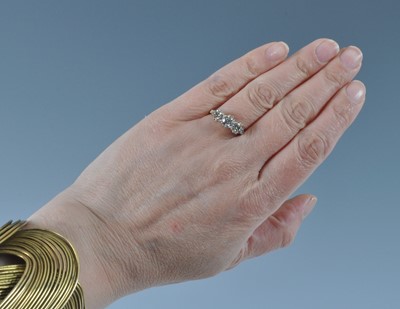 Lot 1162 - A yellow and white metal diamond three stone...