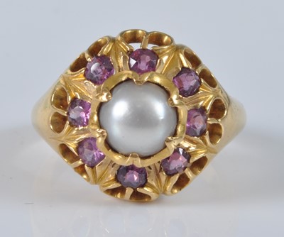 Lot 1147 - A yellow metal, pearl and ruby heavy circular...