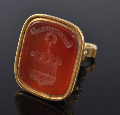 Lot 1135 - A late Georgian yellow metal carnelian seal...