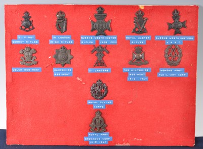 Lot 294 - A small collection of cap and collar badges,...