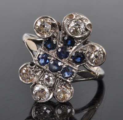 Lot 1191 - A white metal 'fleur de lys' sapphire and...